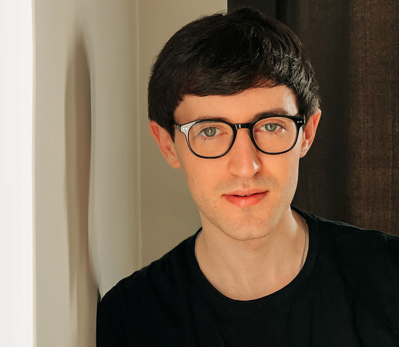 Photo portrait of Matthew, with a sincere, slight smile, looking at the reader.